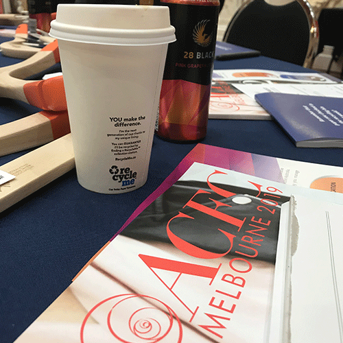 Image of RecycleMe cup sitting on a table with the Australian Circular Fashion Magazine